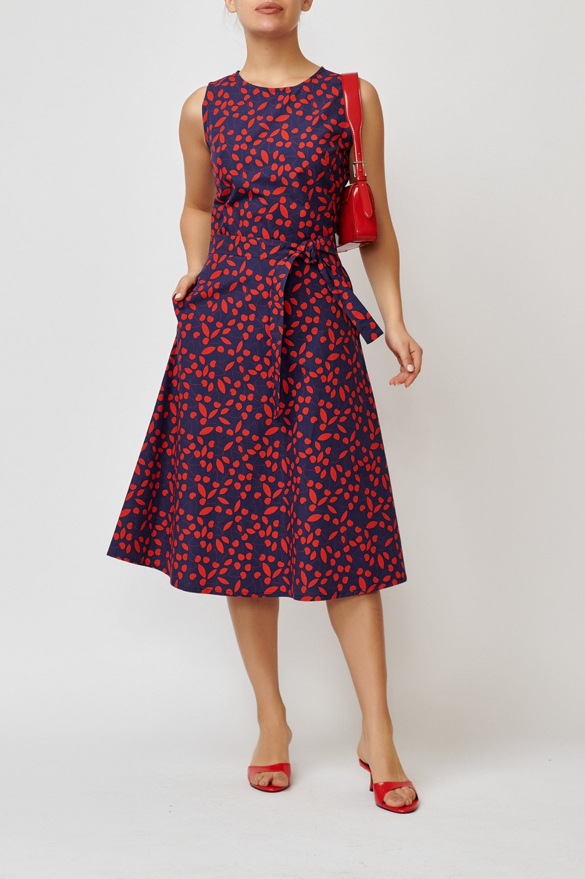 Sleeveless poplin dress with cherries on navy blue