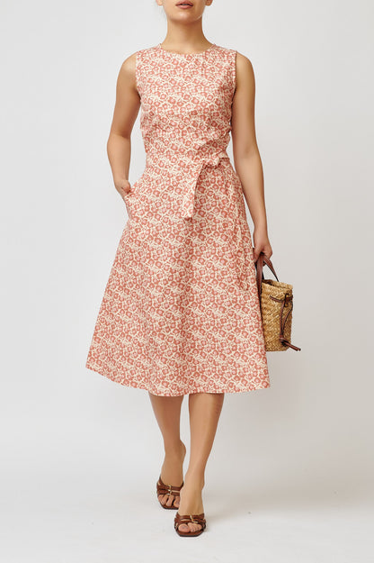 Sleeveless poplin dress with brick flowers on a cream background