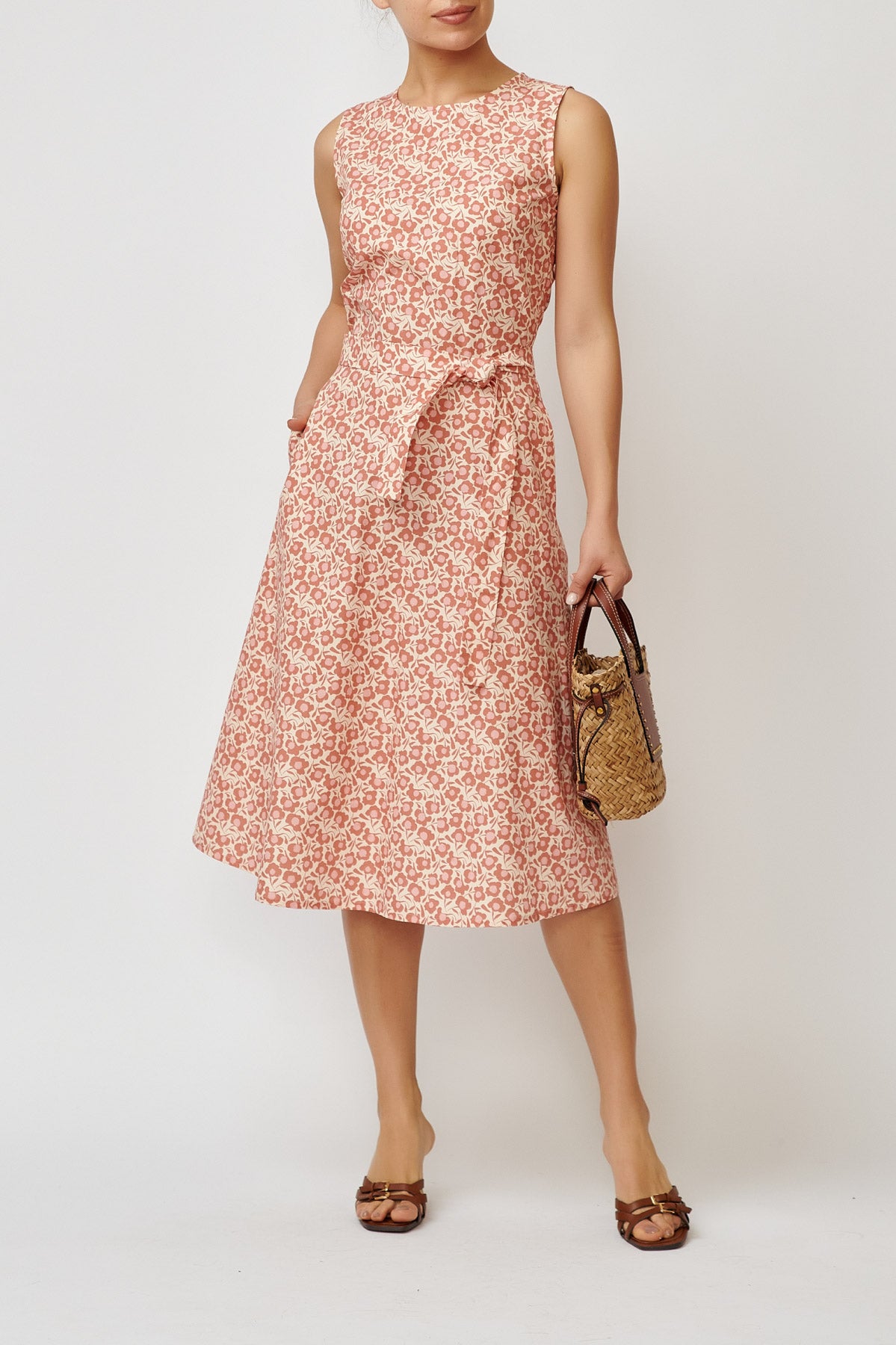 Sleeveless poplin dress with brick flowers on a cream background