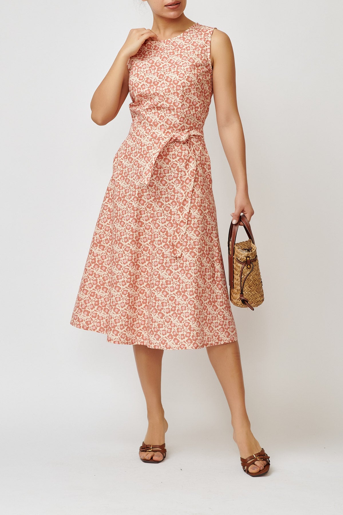 Sleeveless poplin dress with brick flowers on a cream background