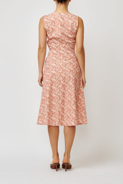 Sleeveless poplin dress with brick flowers on a cream background